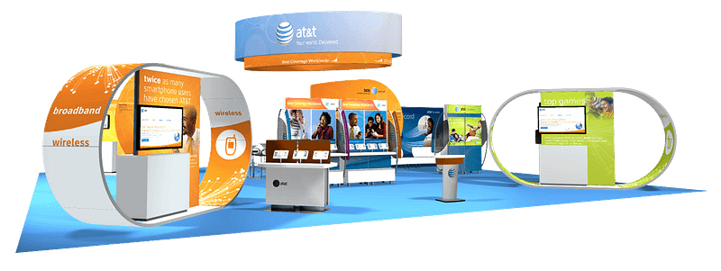 Large trade show booth with multiple touch points and graphics hanging from the ceiling.