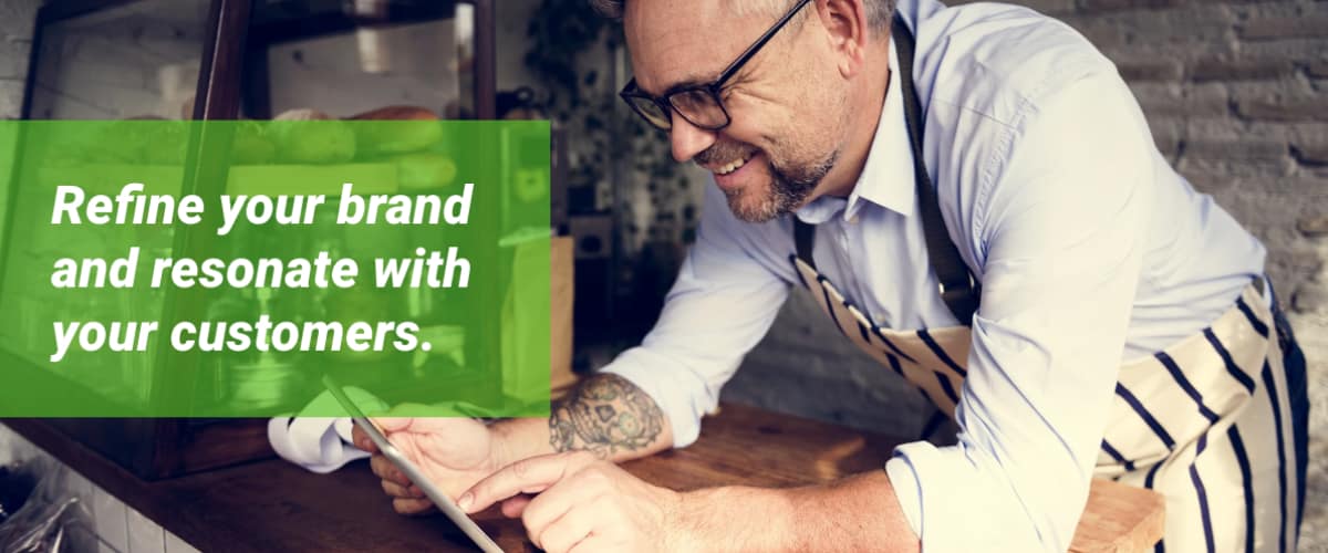 Retailer leaning against a counter.