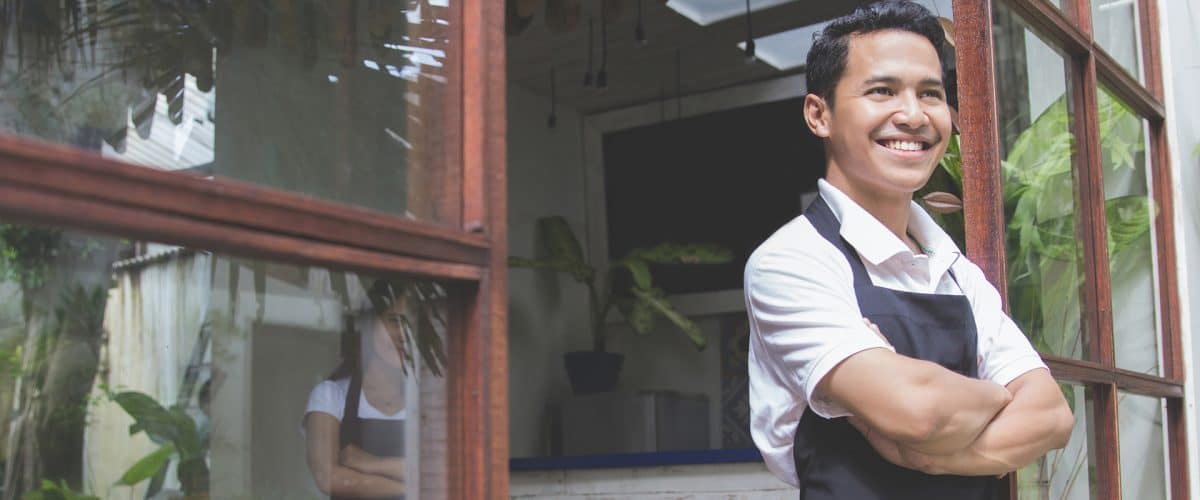 Image of a happy and successful shop owner who has elevated his branding.